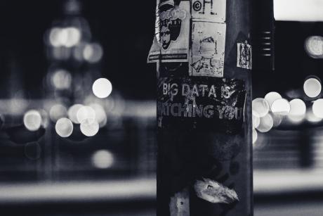 A graffiti on an electric post that reads 'Big Data is Watching You'